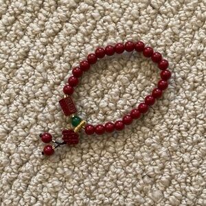 Red Beaded Bracelet With Chinese Design and Small Green Bead